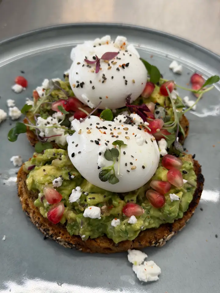 Zen avocado toast with poached eggs, feta and pomegranate