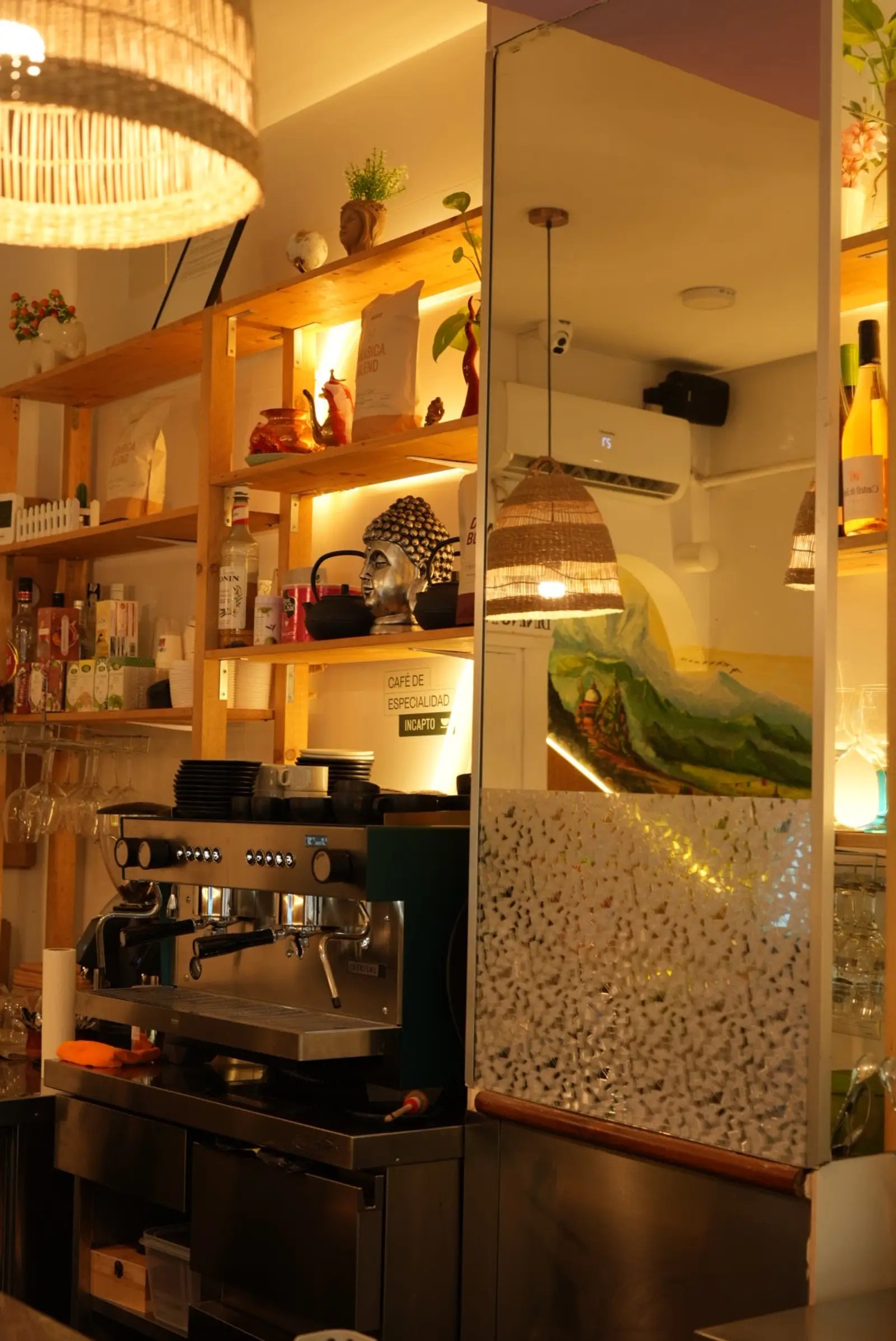 The espresso bar in warm evening light, with a Buddha head on the shelf